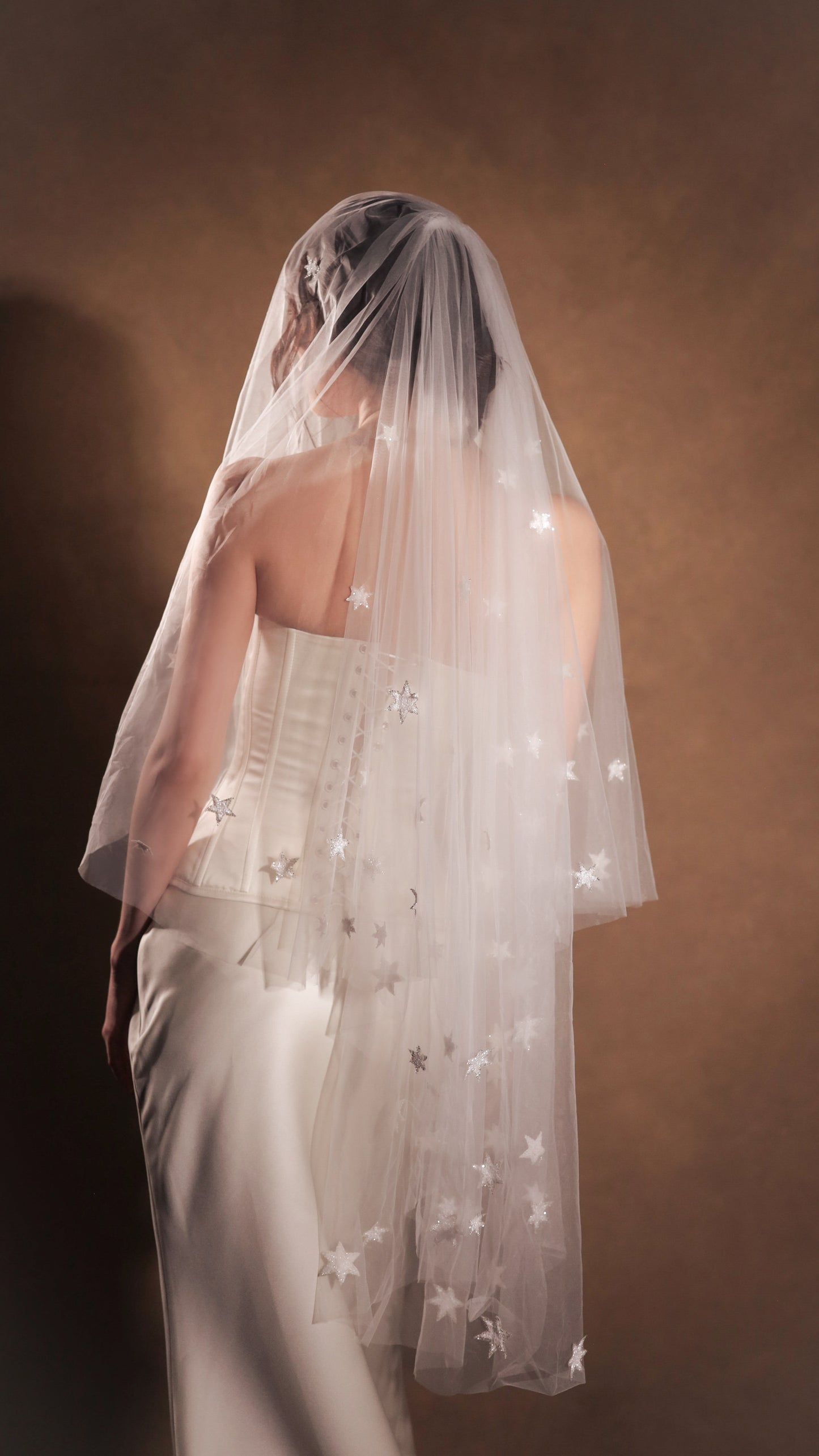 Two-tier bridal veil with blusher, adorned with glowing stars, crafted from soft French tulle in a soft white sheer hue, by Boom Blush.