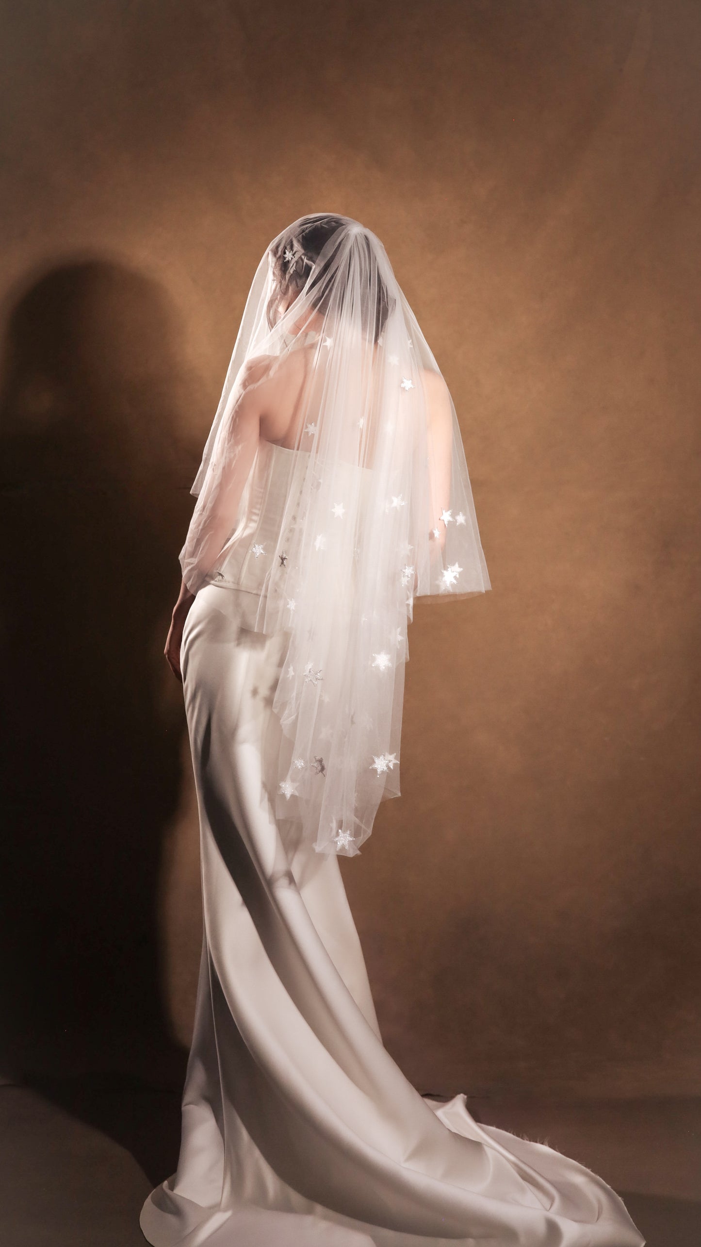 Two-tier bridal veil with blusher, adorned with glowing stars, crafted from soft French tulle in a soft white sheer hue, by Boom Blush.