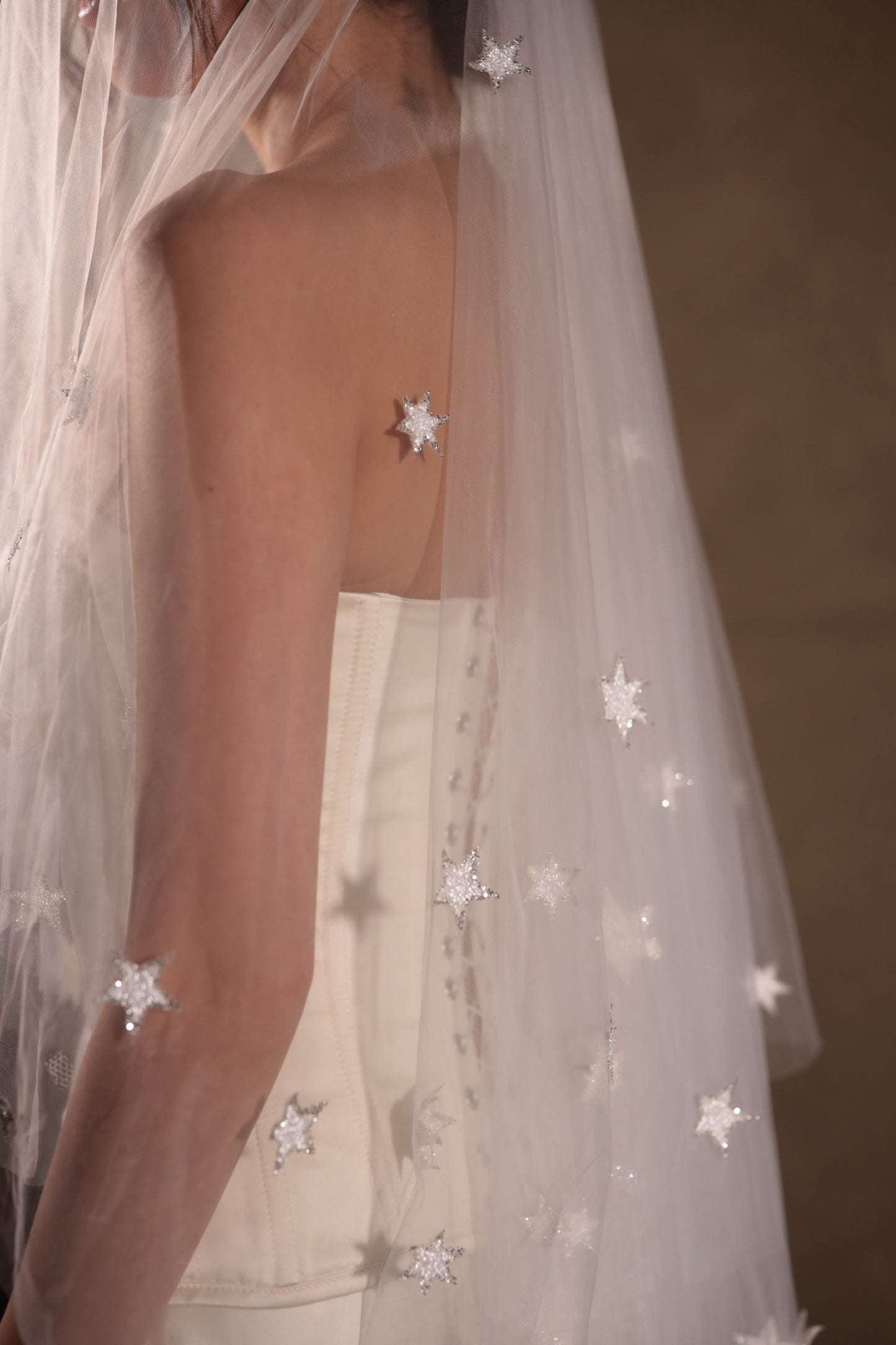 Two-tier bridal veil with blusher, adorned with glowing stars, crafted from soft French tulle in a soft white sheer hue, by Boom Blush.