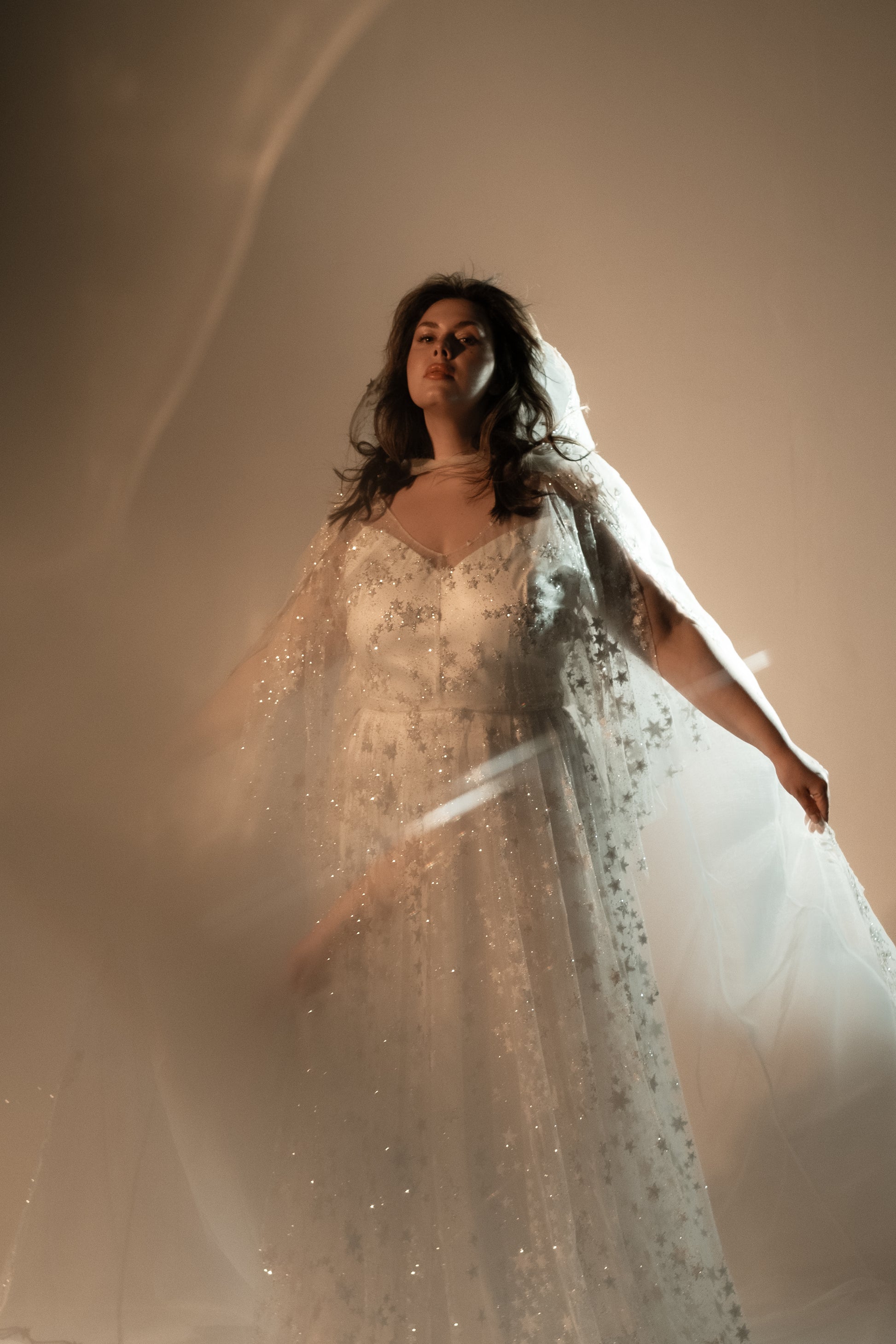 Boho plus size romantic bride in glow lace gown under sunset light
