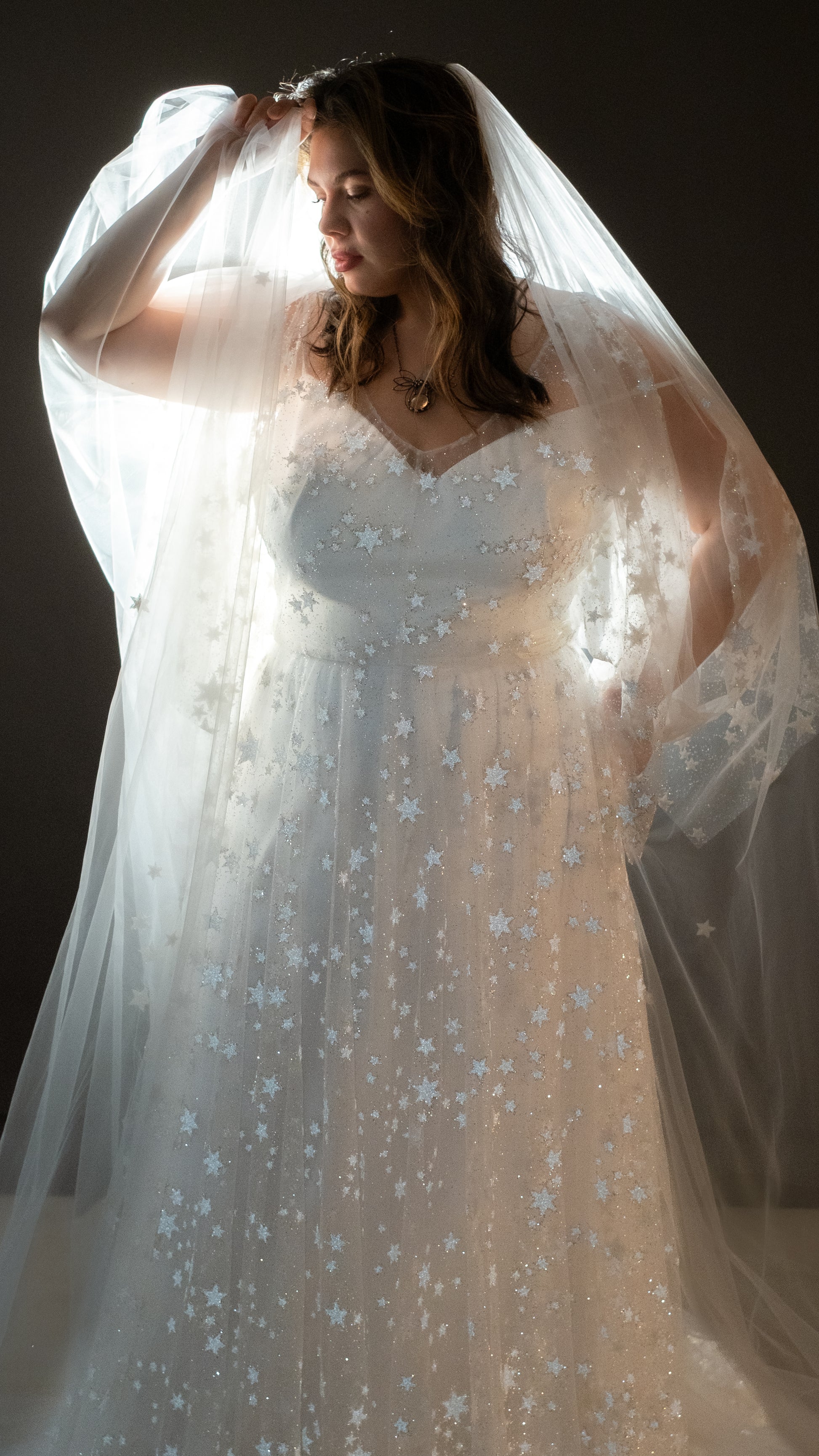 Boho plus size bride in glow lace gown under sunset light