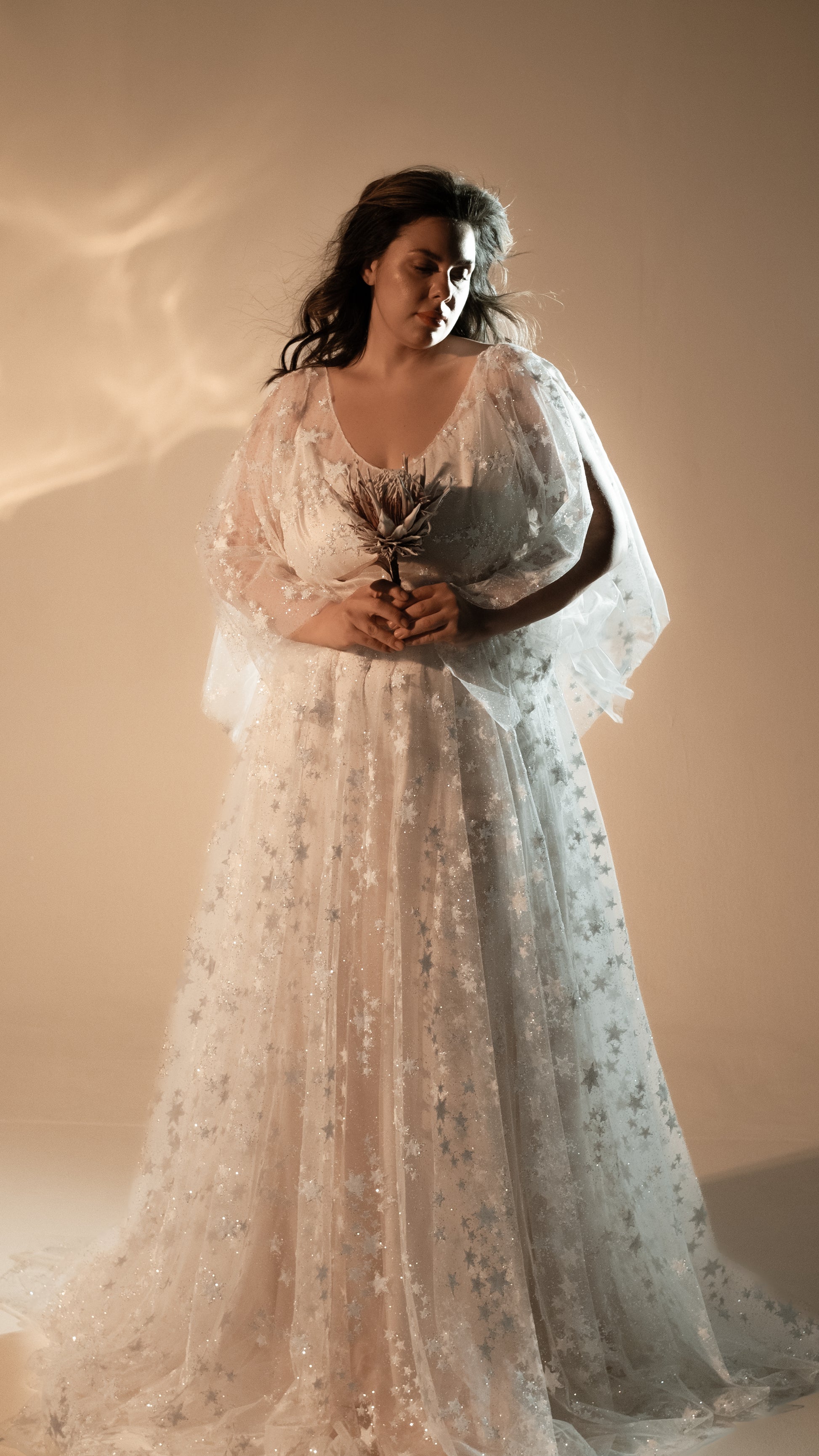 Boho plus size romantic bride in glow lace gown under sunset light