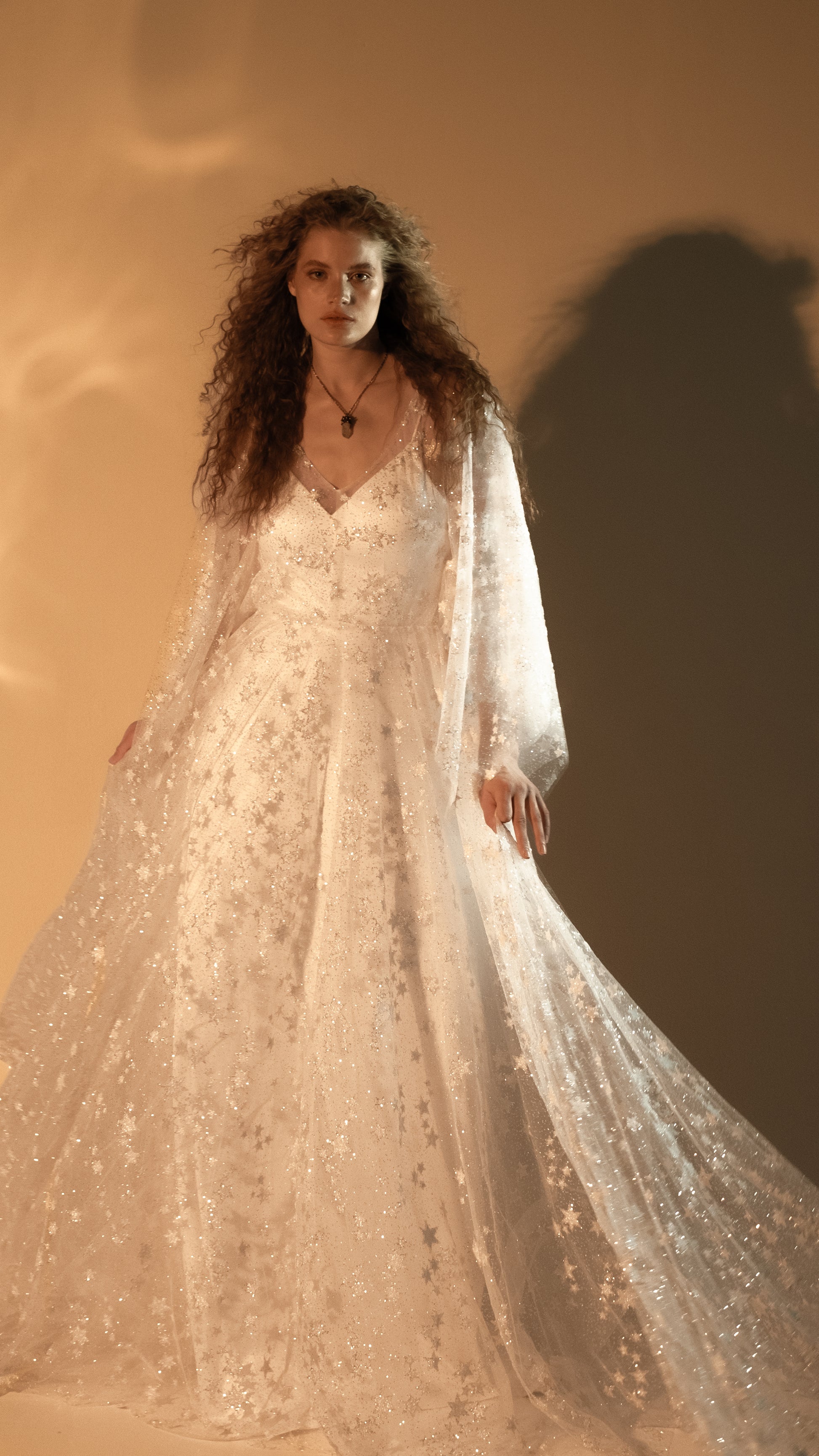 Boho bride in glow lace gown under sunset light
