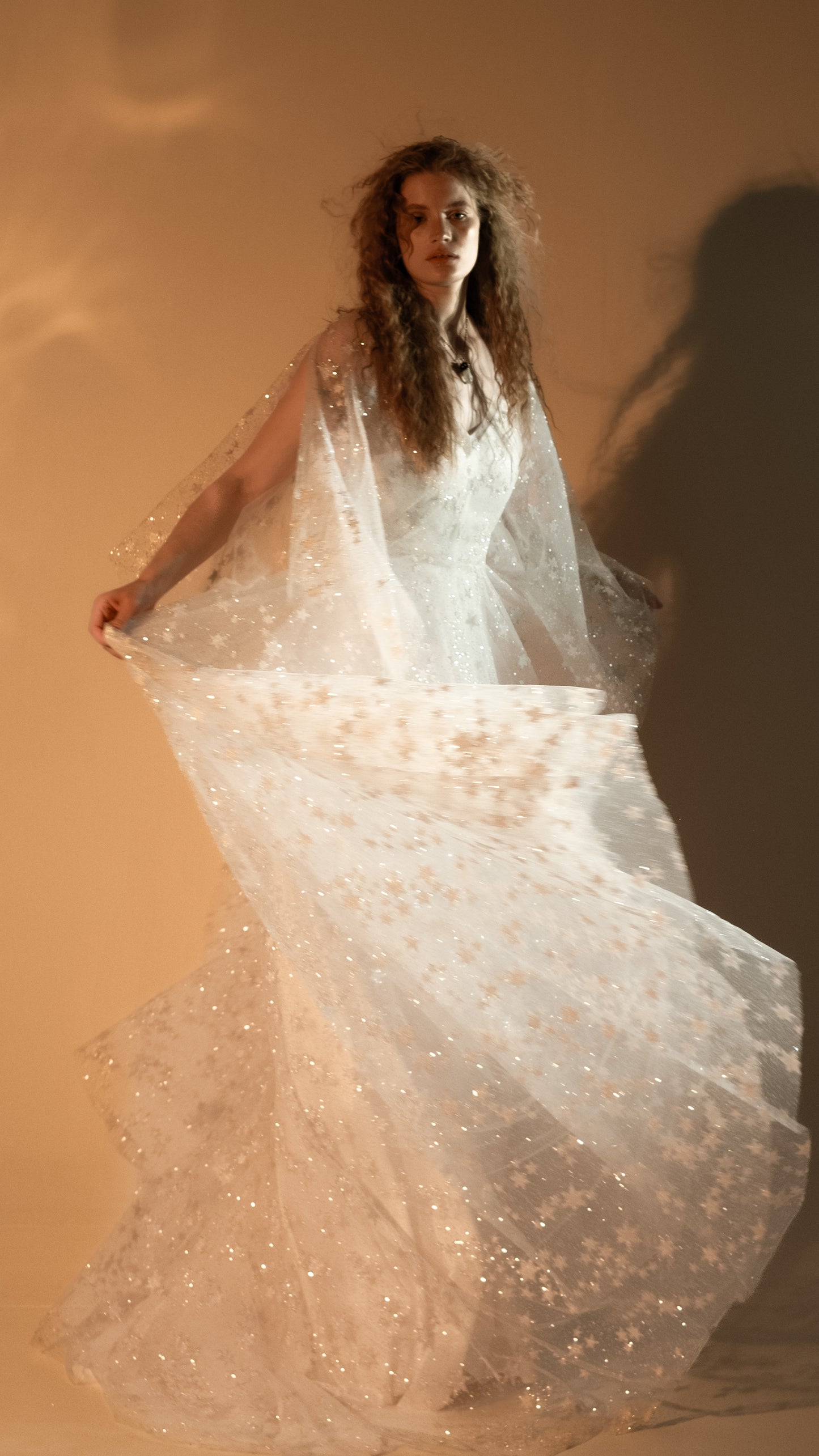 Boho bride in glow lace gown under sunset light
