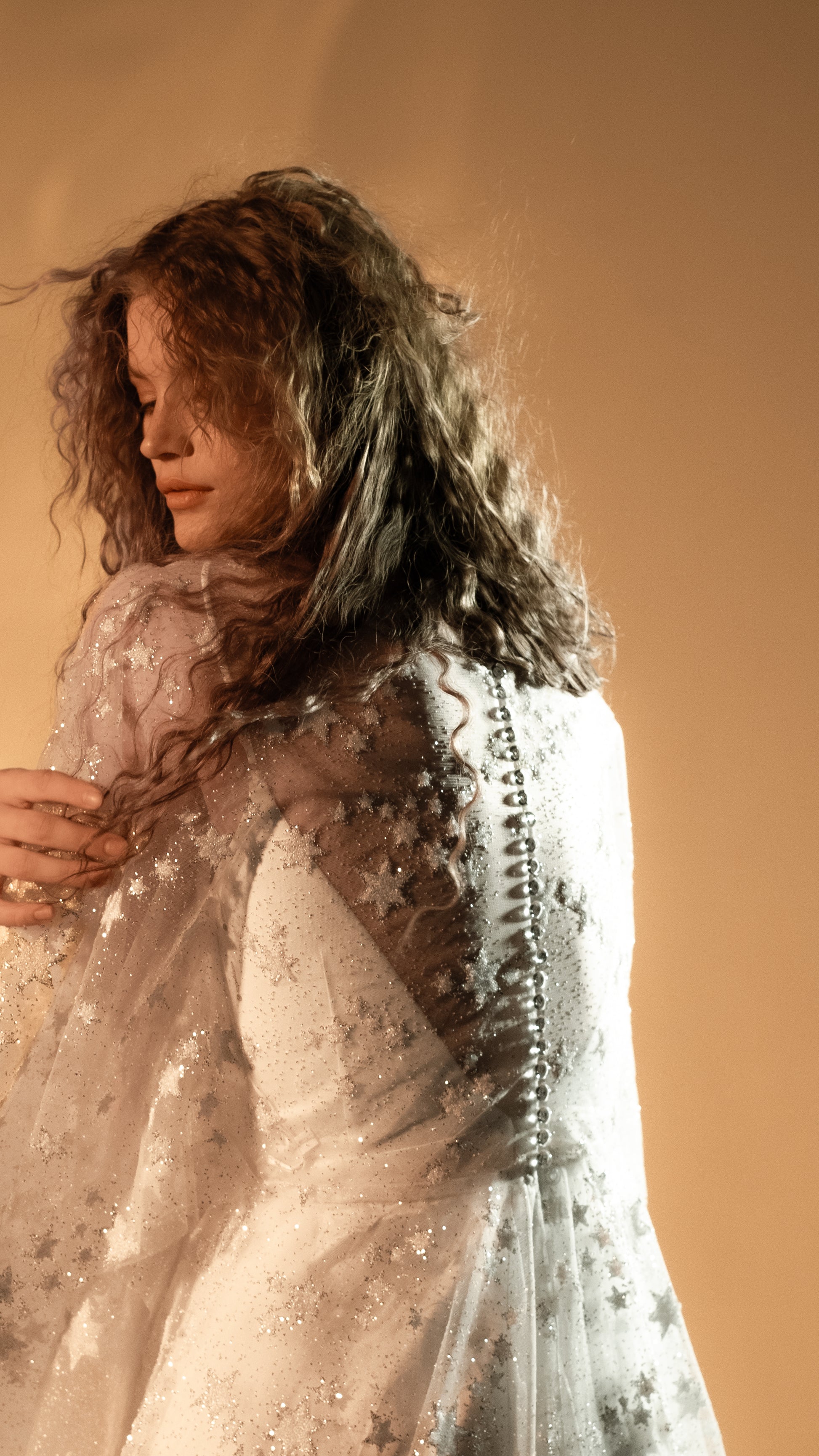 Boho bride in glow lace gown under sunset light