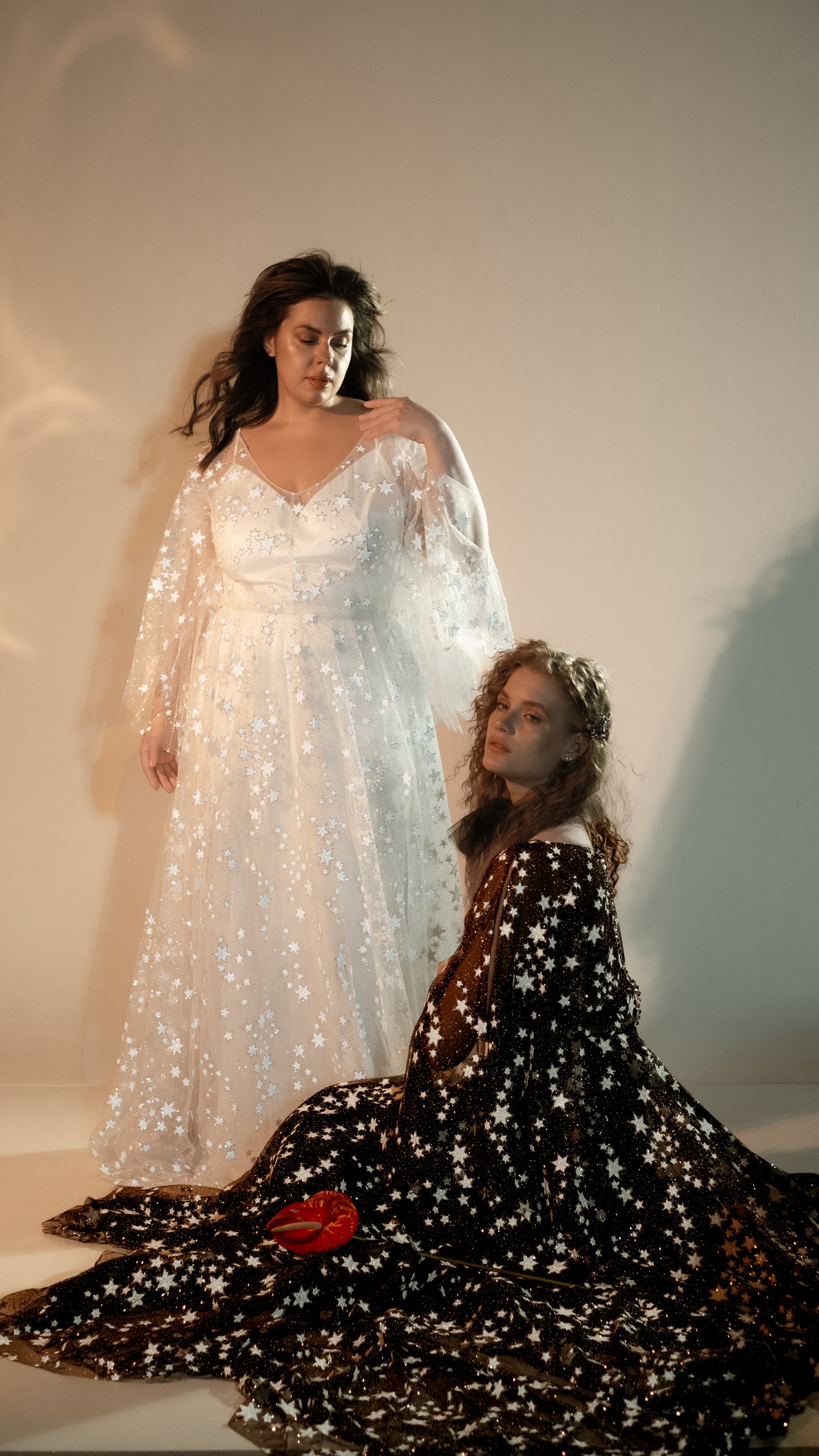 Brides wearing glow-in-the-dark star wedding dresses in ivory and black lace