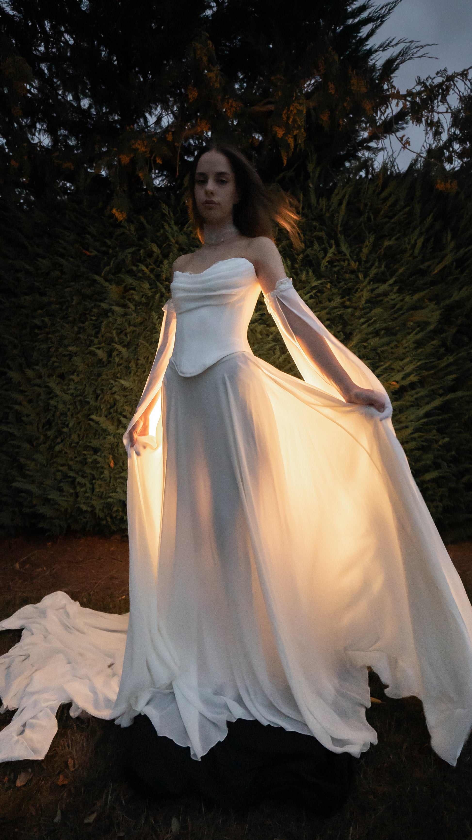 Venus bridal ensemble featuring ivory satin corset, A-line chiffon skirt with train, and starry Feyre Sleeves by Boom Blush. Venus bridal ensemble featuring ivory satin corset, A-line chiffon skirt with train, and starry Feyre Sleeves by Boom Blush.