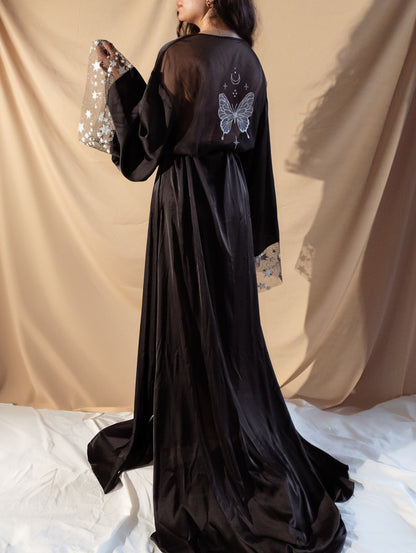 Bride wearing black bridal robe with stars and butterflies 