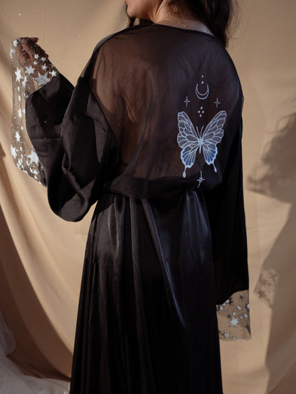 Bride wearing black bridal robe with stars and butterflies 