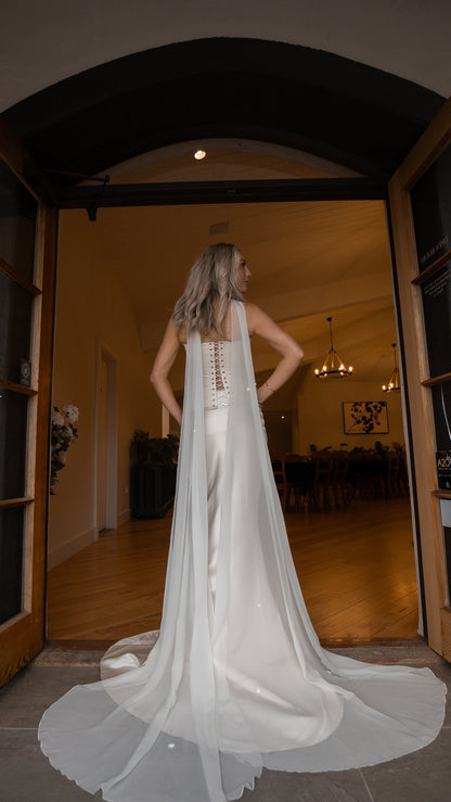 bride wearing white neck scarf veil