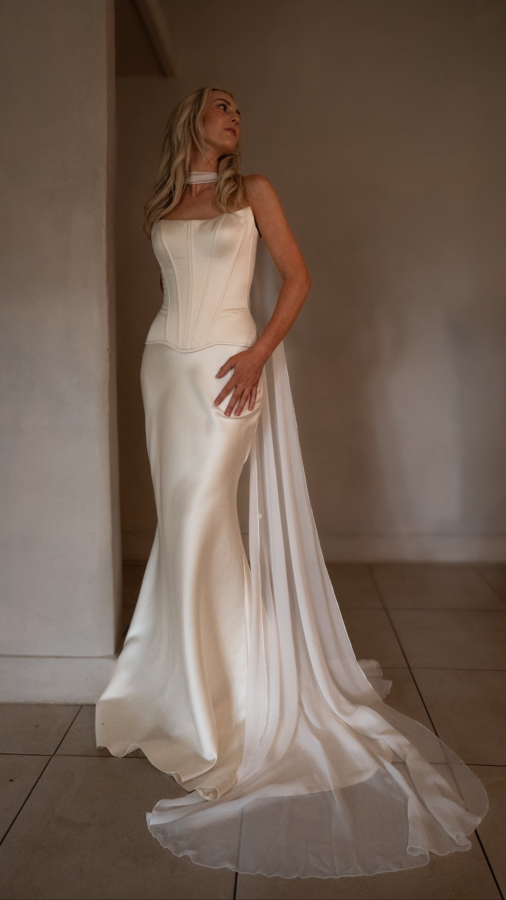 bride wearing drop waist gown and neck scarf